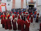 Mustang Lo Manthang Tiji Festival Day 3 07-2 Monks Pray Near Main Gate We all run along side the monks who stop briefly just outside the city gate of Lo Manthang at the end of the third day of the Tiji Festival in Lo Manthang.